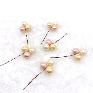 Christmas foam berry ornaments in pastel macaron pink and gold on soft white faux fur