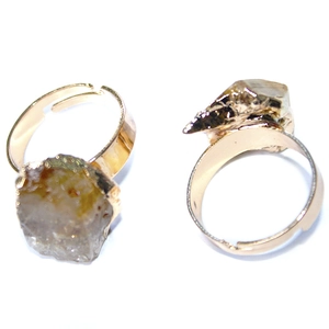 Adjustable gold plated rings with natural irregular citrine stones on white background