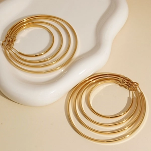 Polished golden stainless steel hoop earrings set in five versatile sizes for women