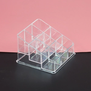 Macro shot of clear acrylic tiered lipstick organizer with multi-compartment storage slots