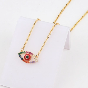 Close-up of 18k gold evil eye heart pendant with colorful zircons and red enamel