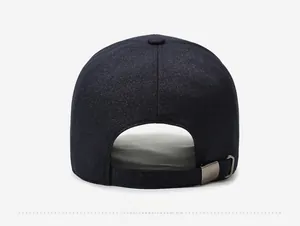 Detail of adjustable metal buckle and navy blue fabric texture on back of baseball cap