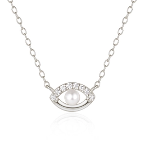 Macro detail of S925 sterling silver evil eye necklace with pearl and pavé diamonds