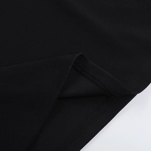 Detail shot of the black dress hem showing professional double-needle stitching quality