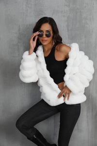 Detail shot of the white faux fur jacket texture and soft plush fibers on fashion model
