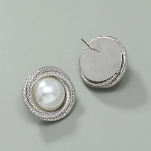 Detail of silver twisted metal earrings with white Baroque pearls and stud closure