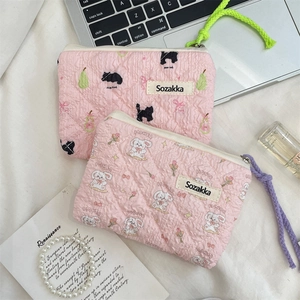 Flat lay of pink floral quilted pouch bags with zipper closure and wrist strap