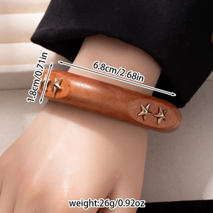 Detail shot of vintage brown wood bangle with star stud showing width and inner diameter