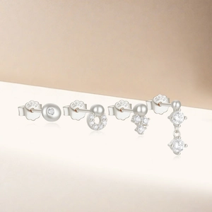 Detailed macro view of four S925 sterling silver stud earrings with clear zircon stones
