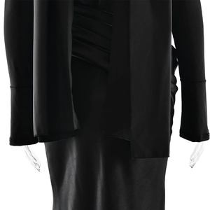 Close-up of ruched waist details and matte fabric on a slim black fishtail dress