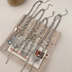 Detailed view of artificial opal necklaces with silver charms and various chain styles