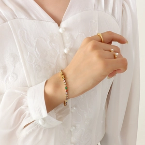 Luxurious gold tennis bracelet with multi-color rainbow cubic zirconia on a wrist
