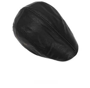 Top view of black leather flat cap showing fine texture and metal ventilation eyelets