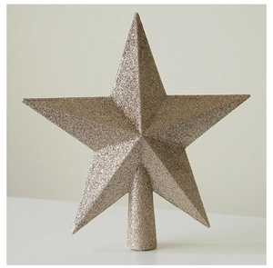 Close-up of a golden glitter Christmas tree star topper showing detailed sparkling texture