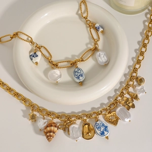 Gold stainless steel necklace with baroque pearls, ceramic floral beads and heart charms