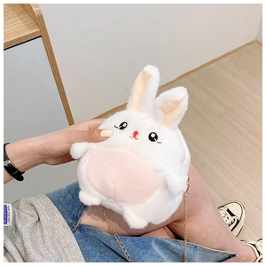 Detail of white plush bunny shoulder bag with golden metal chain strap and pink ears