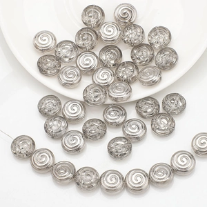 Macro detail of spiral textured silver grey glass beads for DIY jewelry making