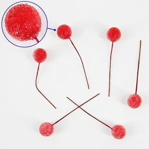 Macro detail of red frosted Christmas berries with textured sand finish and brown stems