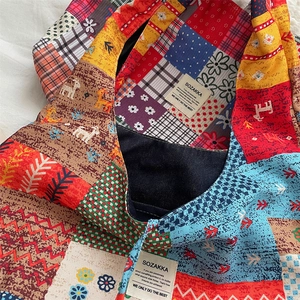Close-up of ethnic corduroy tote bag showing colorful patterns and inner lining detail