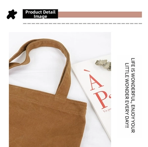 Detail of durable brown canvas tote bag featuring reinforced stitching and premium texture