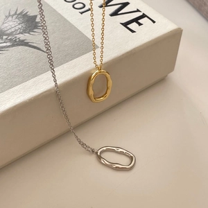 Irregular textured oval pendant necklace in gold and silver minimalist style
