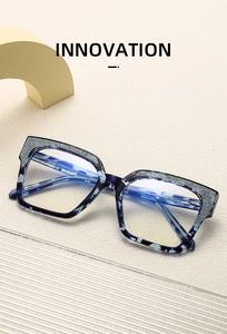 Close-up of blue marble eyeglass frames with glitter details and size 5753 specs