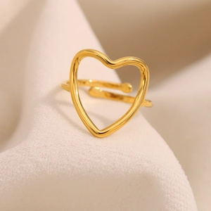 Detail of gold heart open ring showing smooth 18K plated finish on fabric background