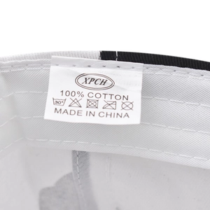 Detailed macro shot of the 100% cotton washing label and care symbols inside the cap