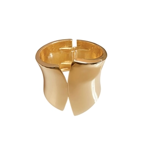 Polished gold irregular wide metal bangle with hinge closure on white background