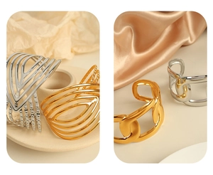 Detailed close-up of 18K gold and silver plated titanium steel wide bangle bracelets