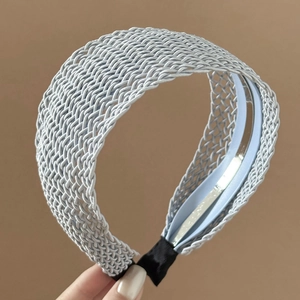 Close-up of light blue braided headband showing intricate woven texture and soft padding