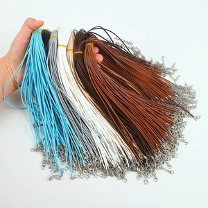 Macro shot of colorful waxed necklace cords with silver lobster clasps and extension chains