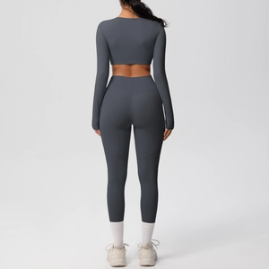 Deep gray yoga set featuring high-waist leggings and long sleeve crop top back view