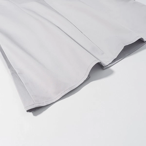 Close-up of light grey suit fabric showing professional stitching and hemline detail
