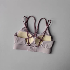Detailed view of criss-cross back straps and 3-row hook closure on sports bra