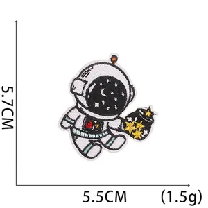 Detailed view of cartoon astronaut embroidery patch with dimensions 5.7x5.5cm and 1.5g weight