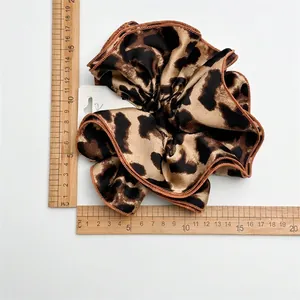 Double-layered leopard print satin scrunchie measuring 12cm diameter on white background
