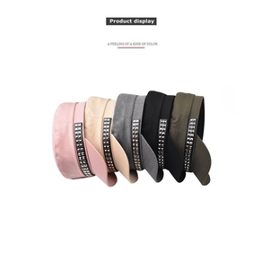 Flat top cadet caps with metallic stud trim in five assorted colors on white background