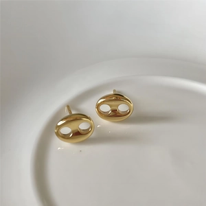 Polished 925 sterling silver gold-plated coffee bean earrings shown on a ceramic tray