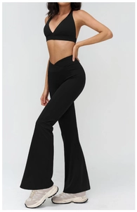 Detailed side view of black high-waisted flare yoga pants with V-shaped waistband