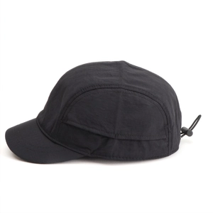 Detail view of the black short brim 5-panel hat showing ripstop texture and drawstring buckle