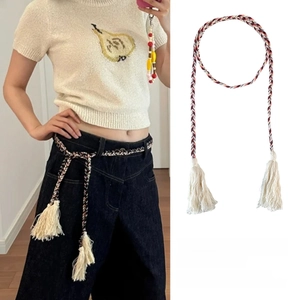 Detail of multi-color braided waist rope with white tassels and bohemian ethnic design