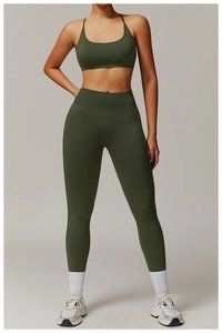 Deep green seamless yoga set featuring a racerback sports bra and high-waisted leggings
