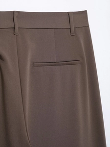 Detailed macro shot of brown twill fabric texture on trousers back pocket and belt loops