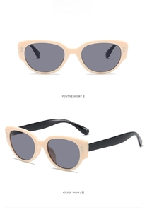 Detail view of retro cat-eye sunglasses with cream frames and grey lenses from two angles