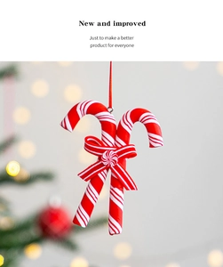 Close-up of red and white striped Christmas candy cane ornament with a matching ribbon bow