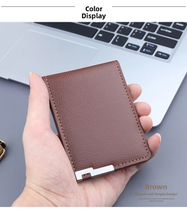 Detailed close-up of brown litchi pattern leather card holder with metal corner