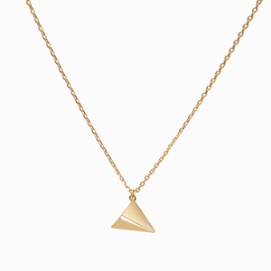 Macro shot of gold paper plane pendant on a layered dainty choker necklace chain