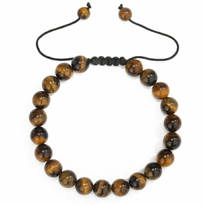 Detail of yellow tiger eye beaded bracelet with adjustable black braided cord on white background