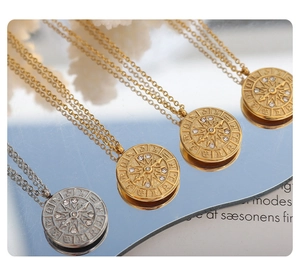 Macro view of 18K gold plated stainless steel zodiac medallion necklaces with zircon
